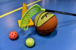 Innebandyklubba, bollar för innebandy, tennis och basket samt en kon.